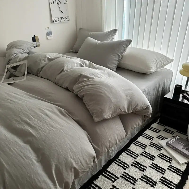 DecorBites™ solid cotton bedding set with gray quilted duvet cover and matching pillows on a bed in various sizes