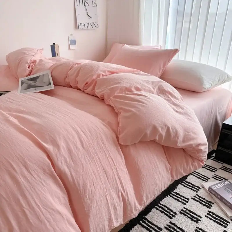 Pink cotton duvet cover bedding set with soft slightly wrinkled texture and matching pillowcases by DecorBites