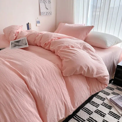 Soft pink solid cotton bedding set with duvet cover and matching pillows featuring a cozy slightly wrinkled texture