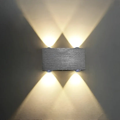 DecorBites™ Sphera modern gray textured stone wall sconces with warm LED lights casting symmetrical beams
