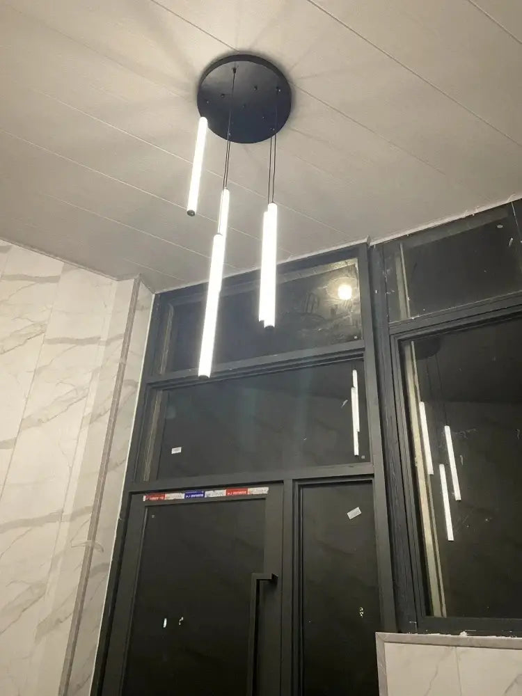 Modern black circular ceiling chandelier led with three vertical white spiral LED light tubes for contemporary homes