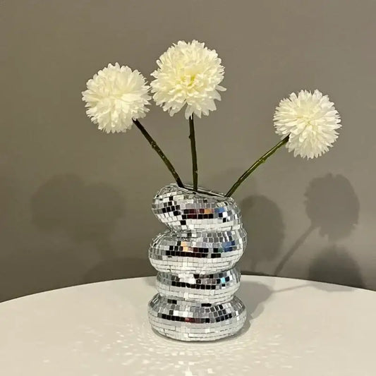 DecorBites™ spiral vase with a reflective mosaic plastic spiral design holds three fluffy white creative flowers