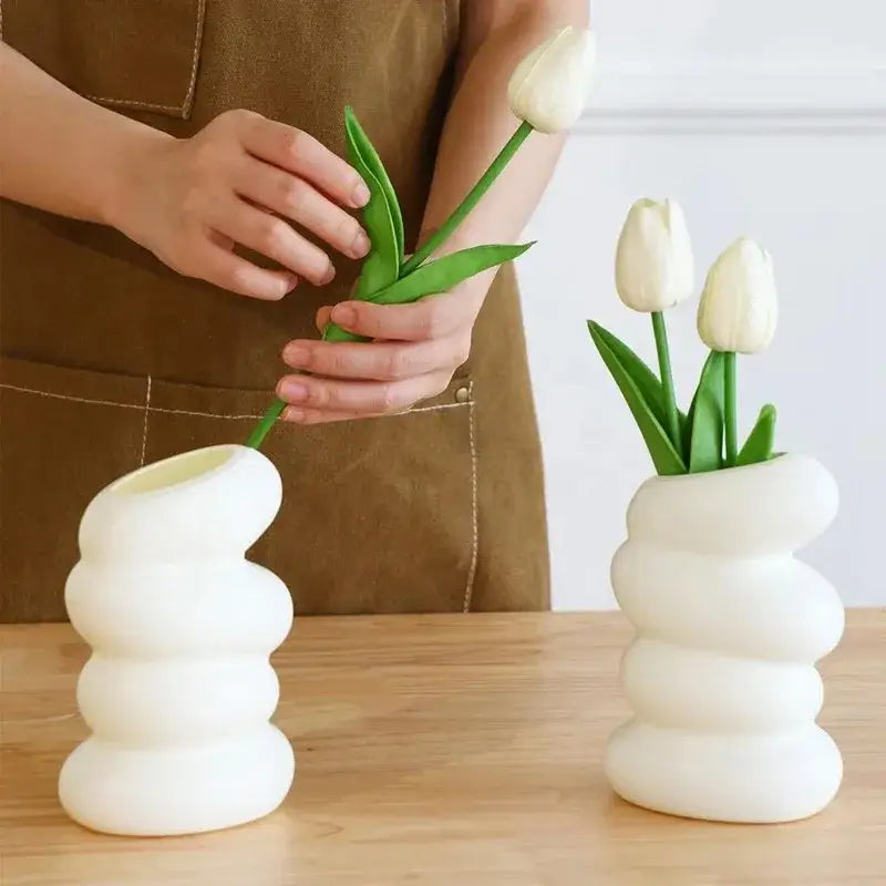 Decorbites spiral white vase is a glossy ceramic white vase with a modern stacked-ringed spiral white design