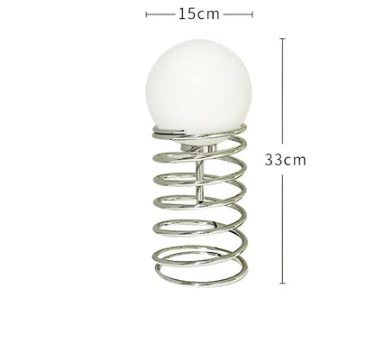 DecorBites™ spring glass table lamp with a chrome spring base and white spherical glass shade for modern decor