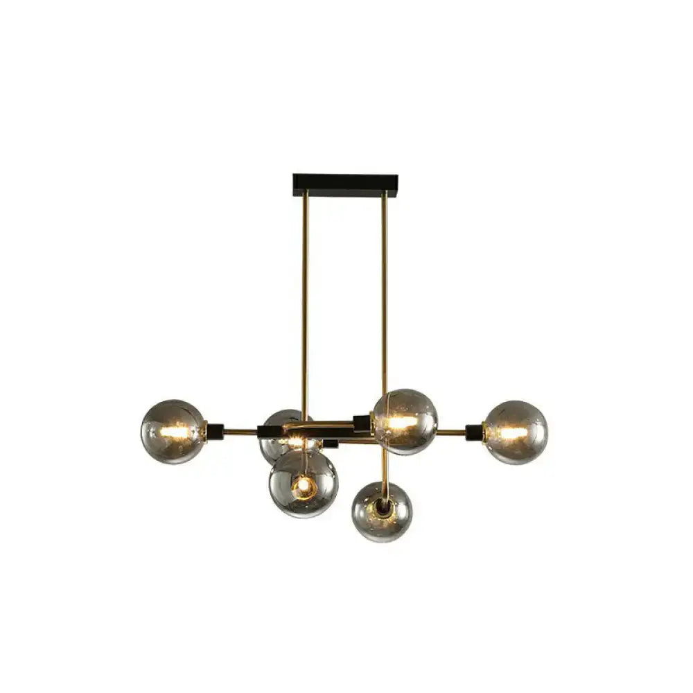 Modern brass and black sputnik hanging island light with six smoked glass globes for dining room illumination