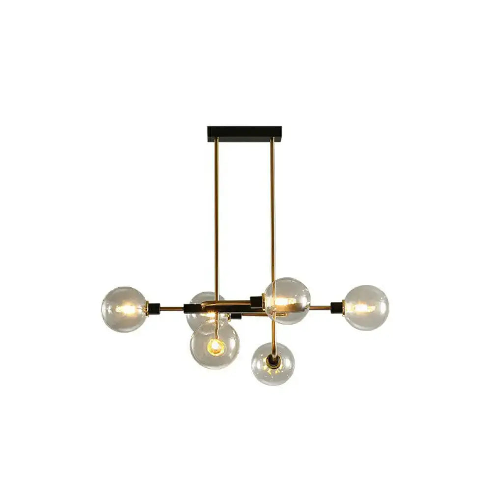 Modern brass and black sputnik hanging island light with clear glass globes for dining room decor by DecorBites™