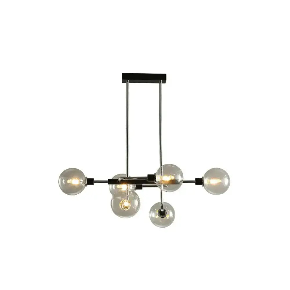 Modern black and chrome sputnik hanging island light with five clear glass globes for dining room decor