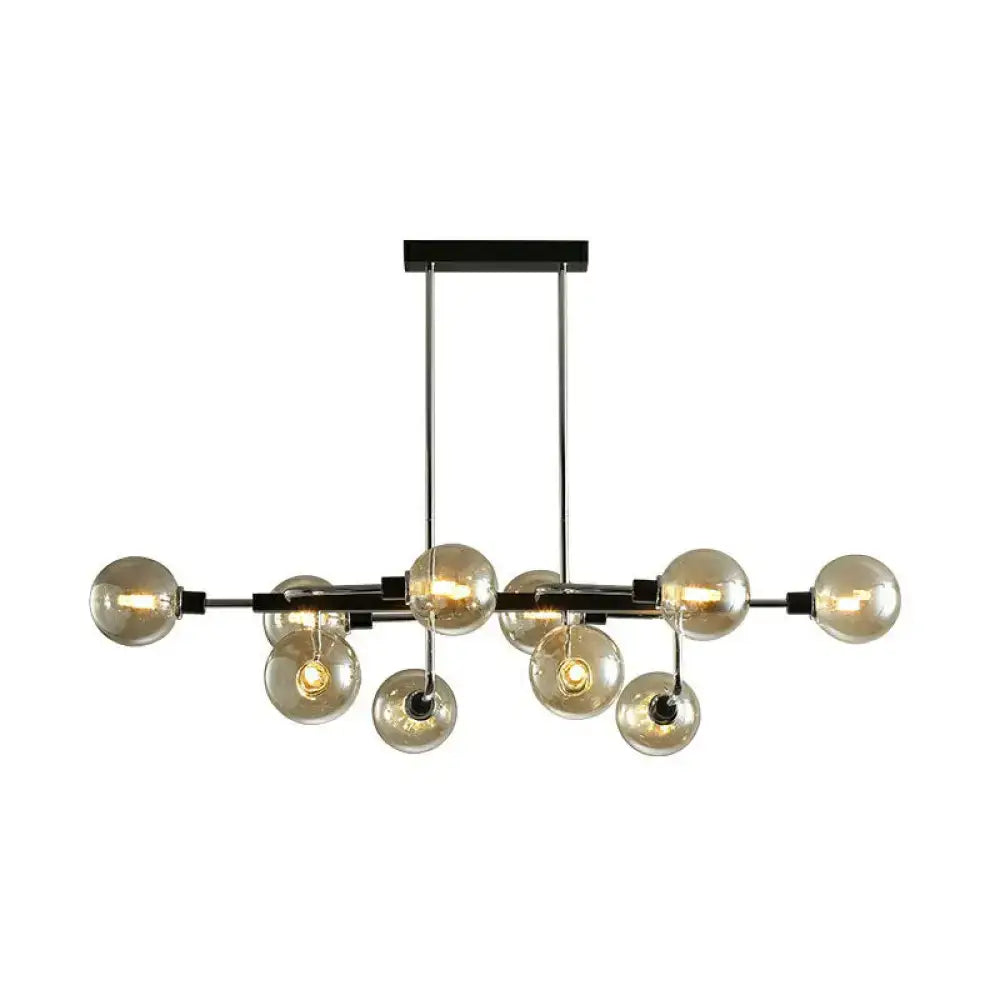Modern black and chrome sputnik hanging island light with amber glass globe bulbs for dining room decor