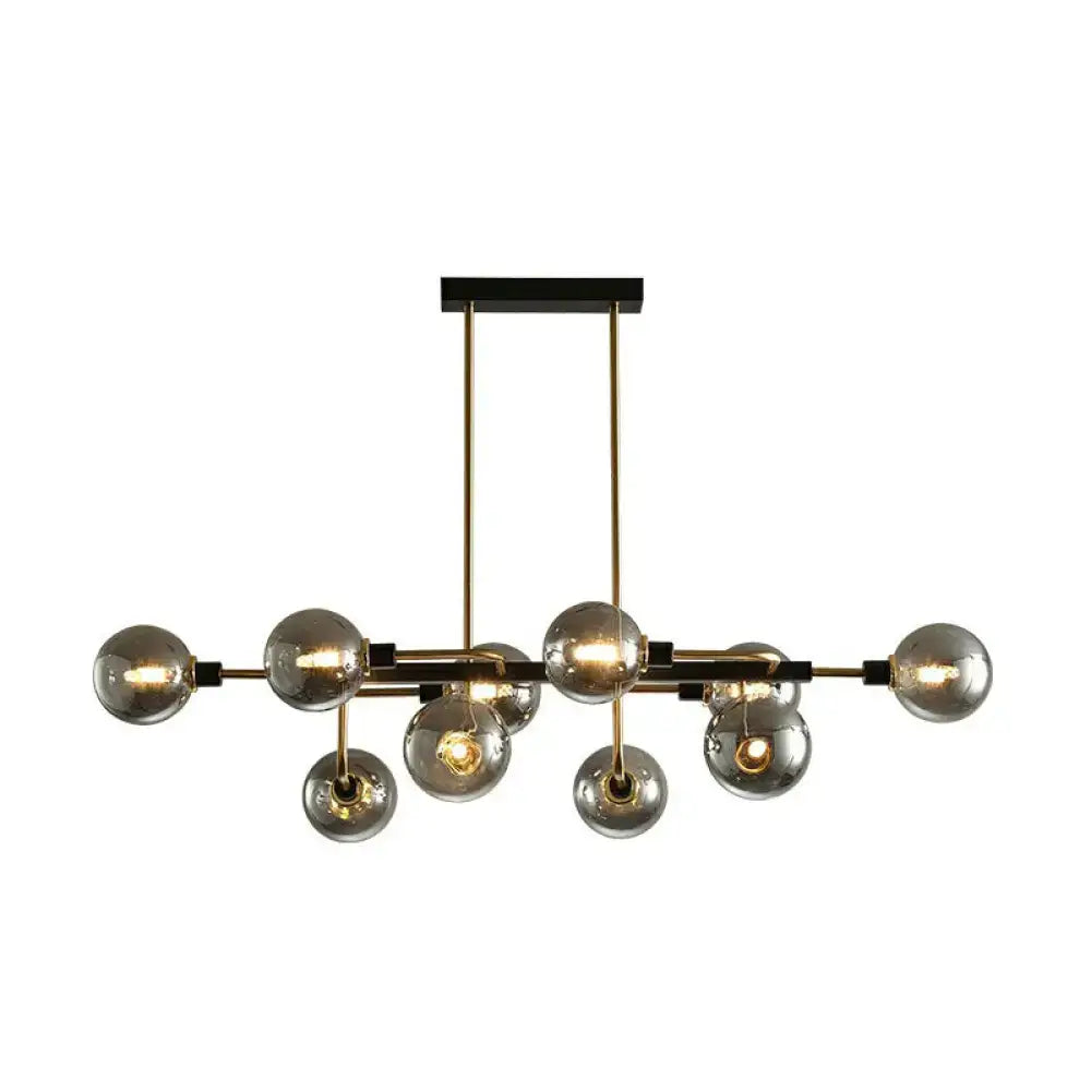 Modern brass and smoked glass sputnik hanging island light with spherical bulbs for dining room decor by DecorBites™