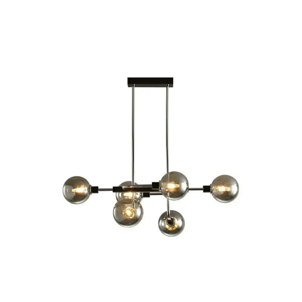 Modern black sputnik hanging island light with six glass bulbs and chrome rods for dining room decor by DecorBites