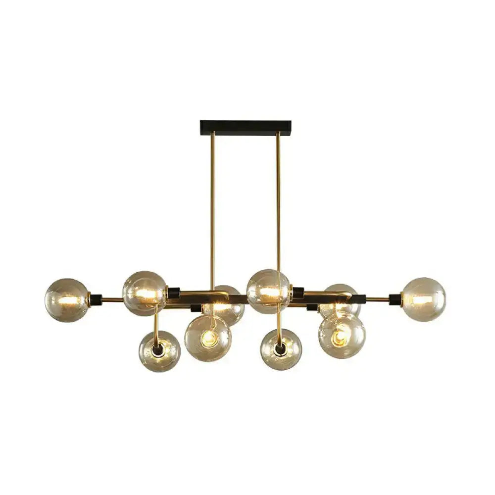 Gold-toned sputnik hanging island light with multiple glass bulbs and black ceiling mount for dining room use