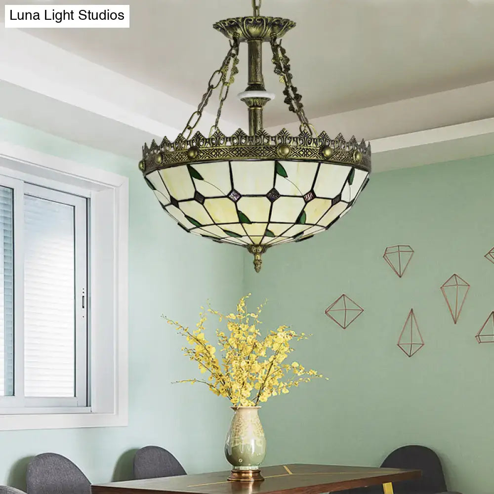 Antique brass-finished stained glass bowl pendant light with cream and green leaded lodge leaf panels for indoor use