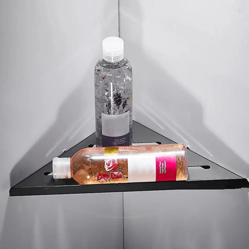Decorbites stainless steel corner shower shelf organizer holding a clear plastic bottle with lavender liquid and purple label