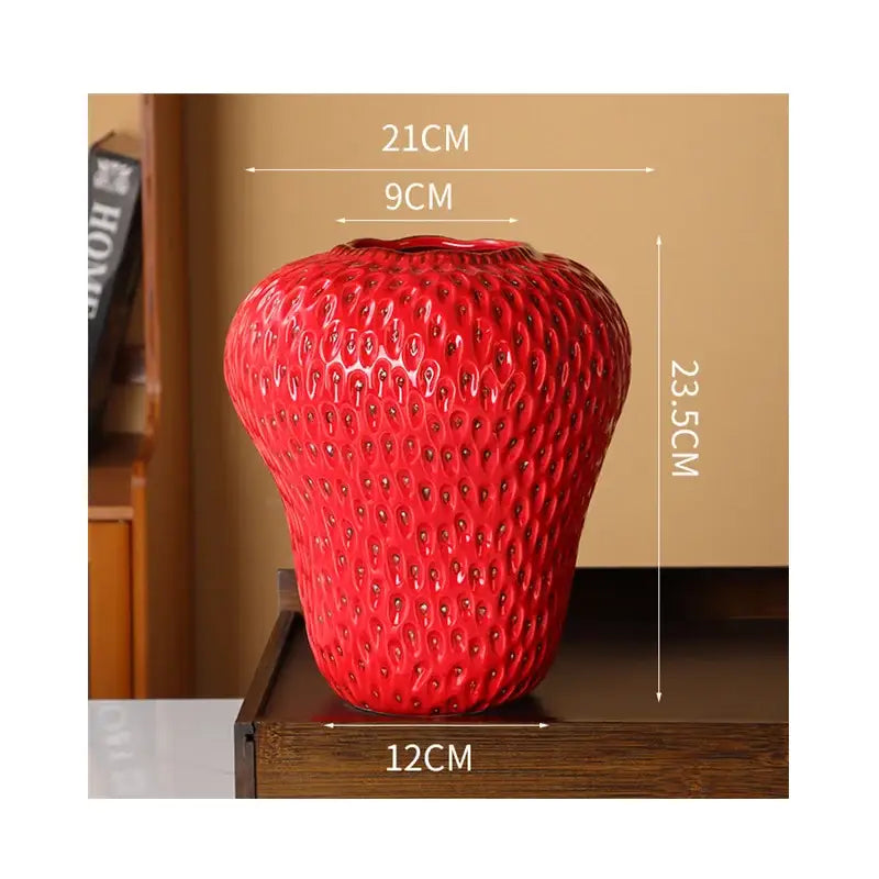 Vibrant red ceramic vase shaped like a strawberry with textured seed bumps for kids room decor by DecorBites™