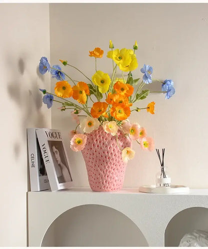 DecorBites™ strawberry cartoon flower vase pink ceramic with textured surface holding vibrant artificial poppies bouquet