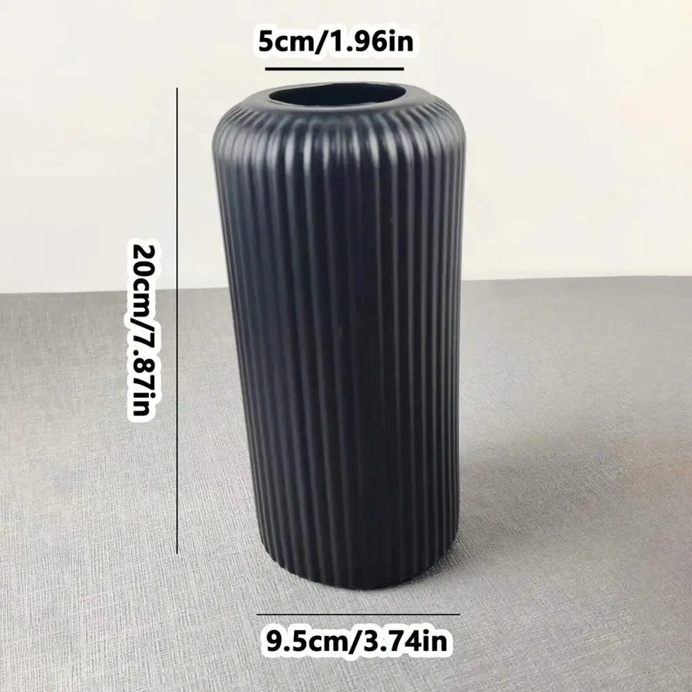 Black ribbed striped ceramic-like plastic vase by decorbites for flowers with a sleek modern design