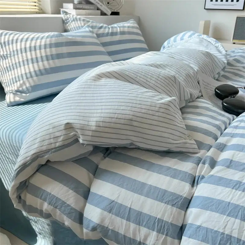 DecorBites™ striped quilt set with pillowcases and sheet featuring blue and white striped bed sheet with textured fabric