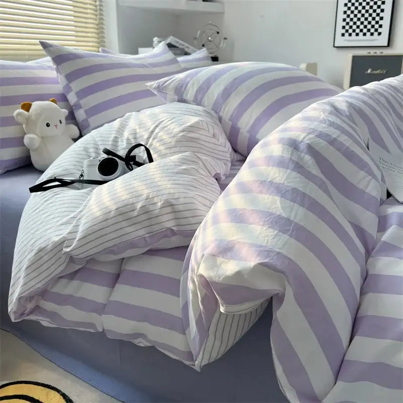 Cozy lavender and white striped quilt set with pillowcases and bed sheet featuring a soft plush texture by DecorBites™