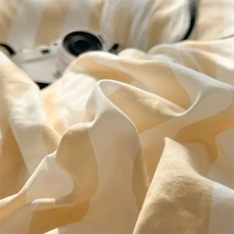 Decorbites™ striped quilt set features soft cream and pale yellow striped fabric with gentle ruffles bed sheet accents