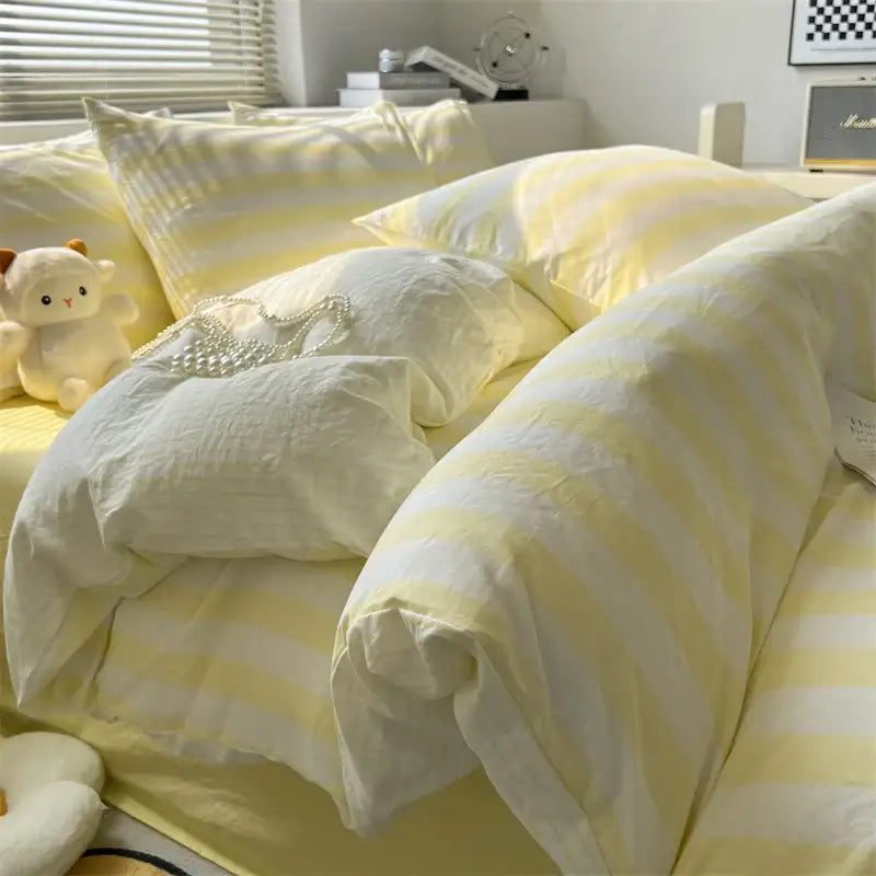 Soft yellow and white striped quilt set by decorbites with a cozy textured fabric finish and matching bed sheet