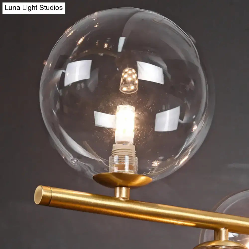 DecorBites™ postmodern suspension lamp with brass finish, glass globe, lotus leaf design, and exposed led bulb inside