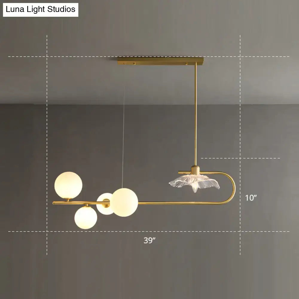 Gold-toned postmodern suspension lamp with frosted glass globe bulbs and delicate lotus leaf design by DecorBites™