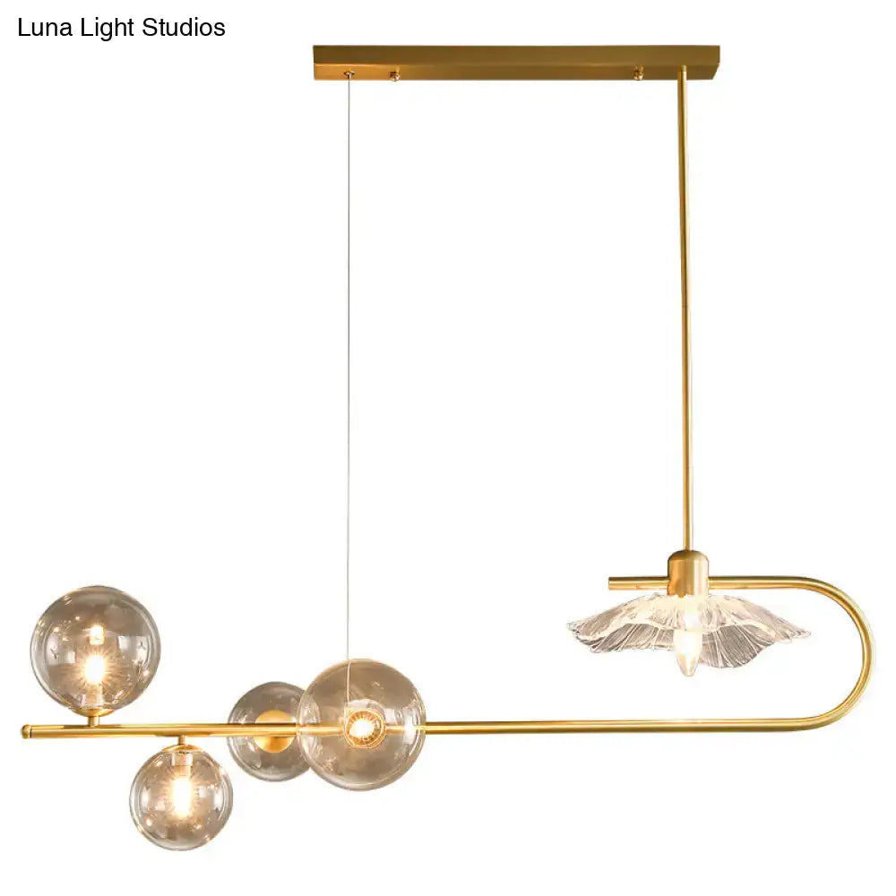 Gold-toned postmodern suspension lamp by decorbites featuring lotus leaf design with glass shade and spherical bulbs