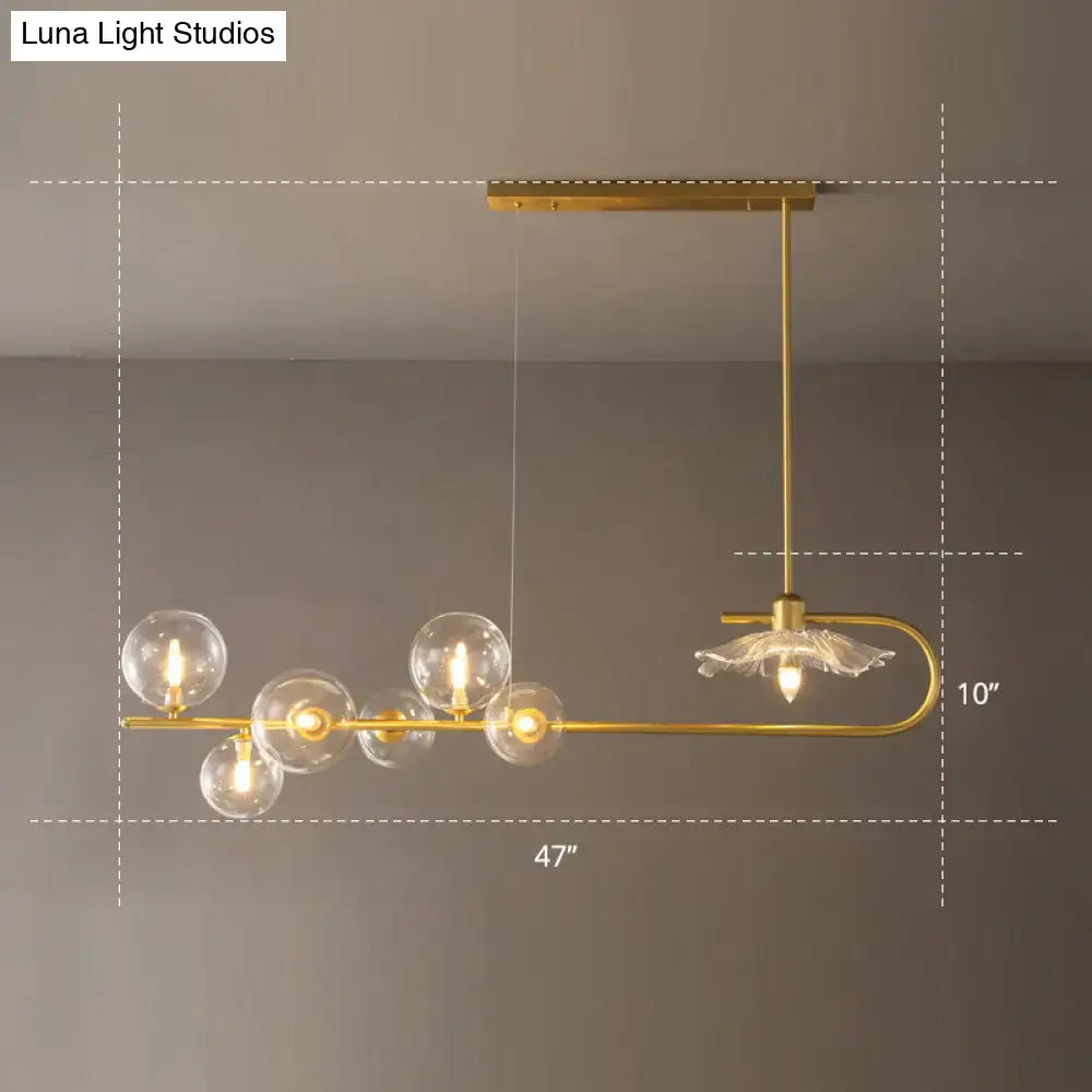 Gold-toned postmodern suspension lamp with clear glass globe bulbs and delicate lotus leaf design floral accent