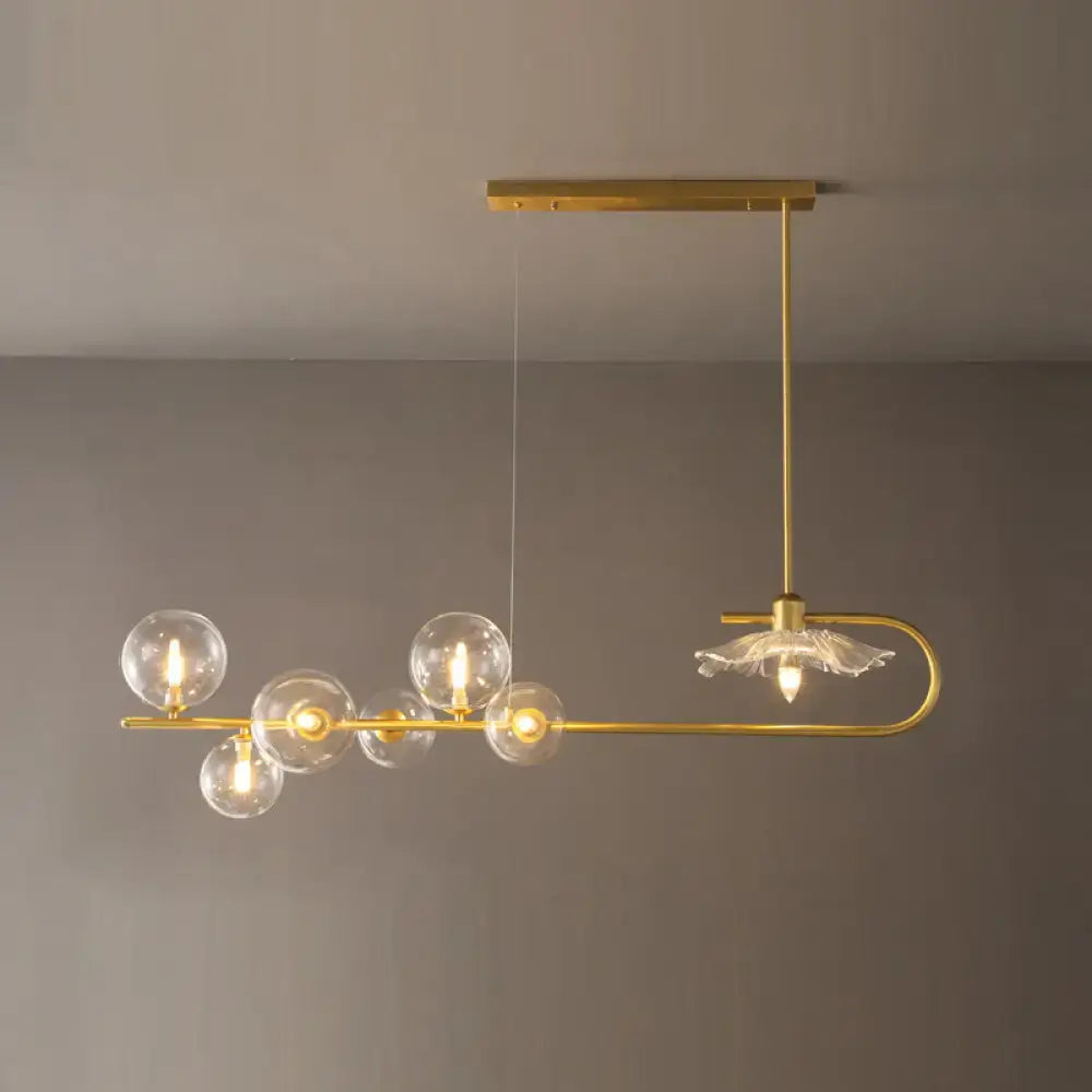Gold-toned postmodern suspension lamp with clear glass globe bulbs and delicate lotus leaf design floral accents