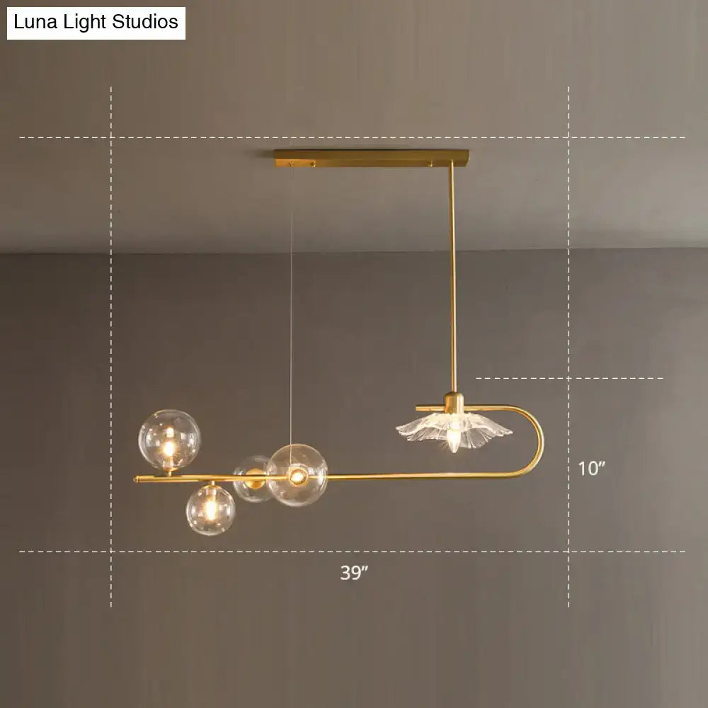 Gold-toned postmodern suspension lamp with clear glass globe bulbs and delicate crystal lotus leaf design accent