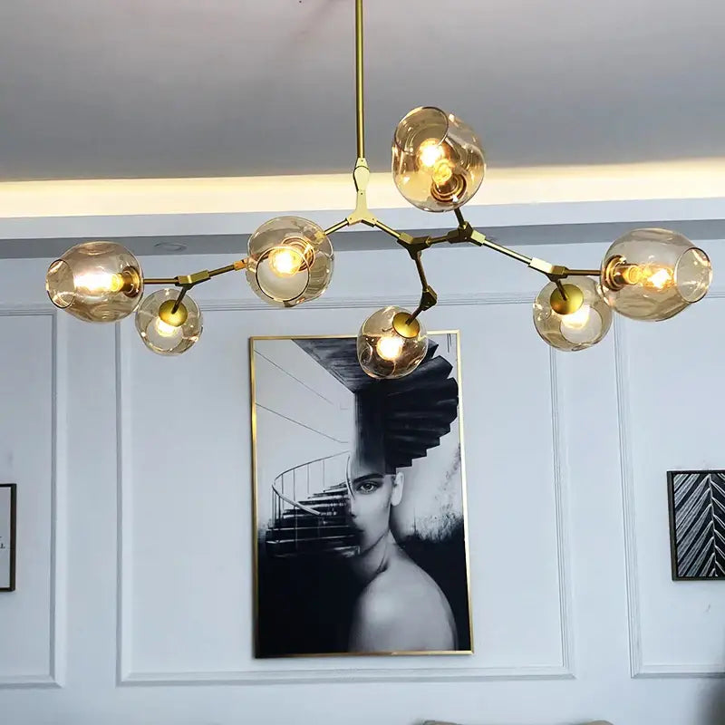Gold-toned modern chandelier by DecorBites with amber glass globes and branching metal frame stylish nordic chandelier