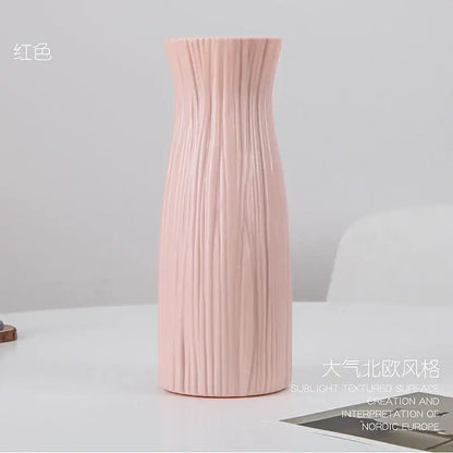A blush pink DecorBites™ plastic flower vase with vertical ribbed texture and sleek modern design for home decor