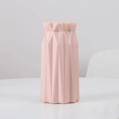 A soft pink plastic flower vase by DecorBites with a geometric faceted design for stylish home decor