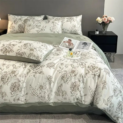 Elegant ivory satin silk duvet cover set with delicate gray floral embroidery and soft sage green border by DecorBites