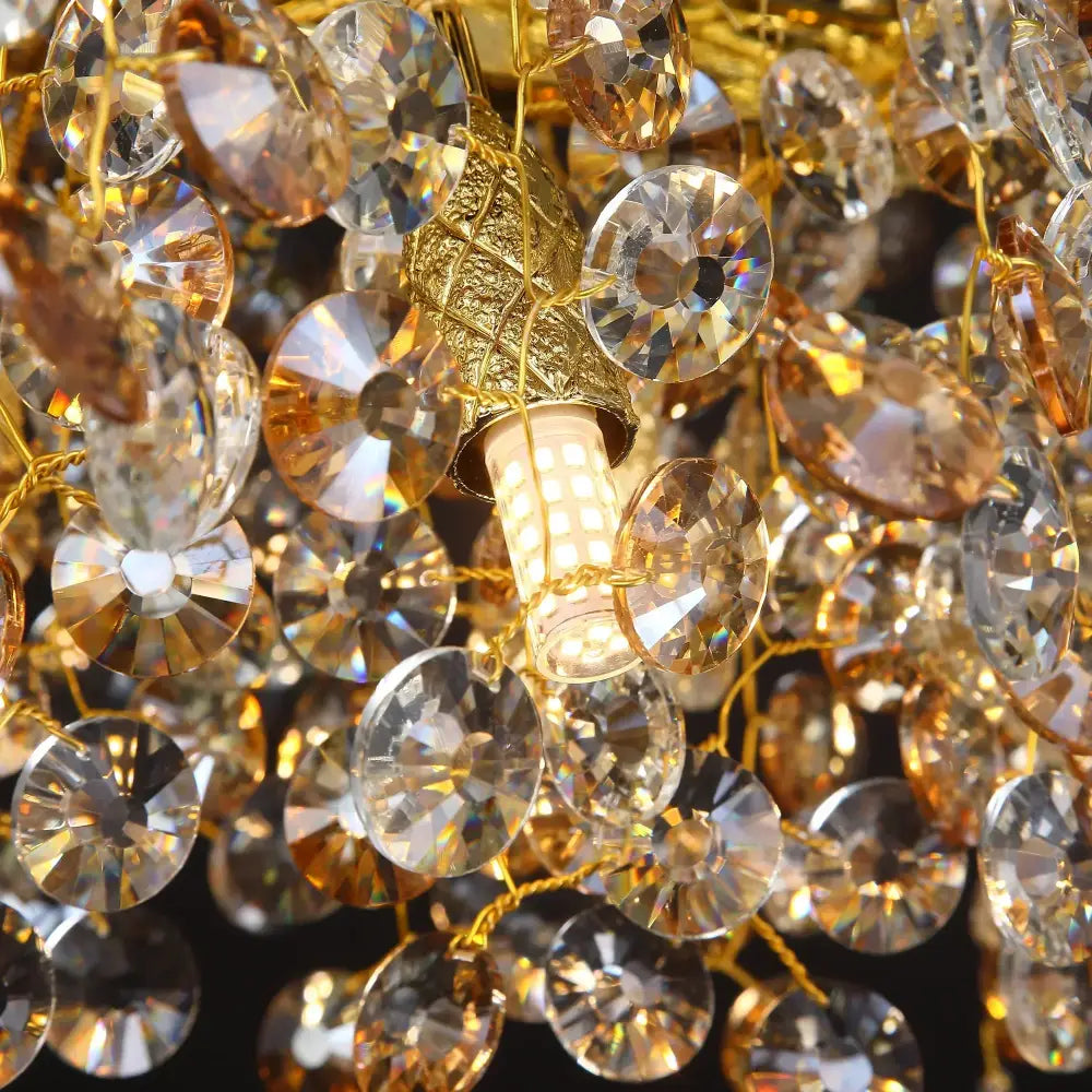 Decorbites sunflower crystal chandelier features a golden frame with faceted crystal droplets and a central led bulb for dining room use