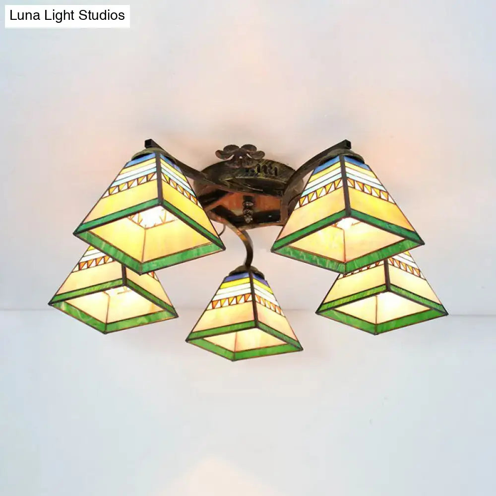Tiffany stained glass ceiling light with antique bronze frame featuring green yellow and blue geometric patterns for bedroom