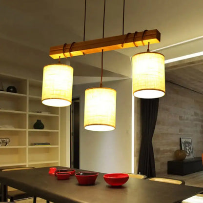 Warm-toned fabric wood pendant barrel lights with woven shades hang from rustic bar ideal for dining room fixture width e26 e27