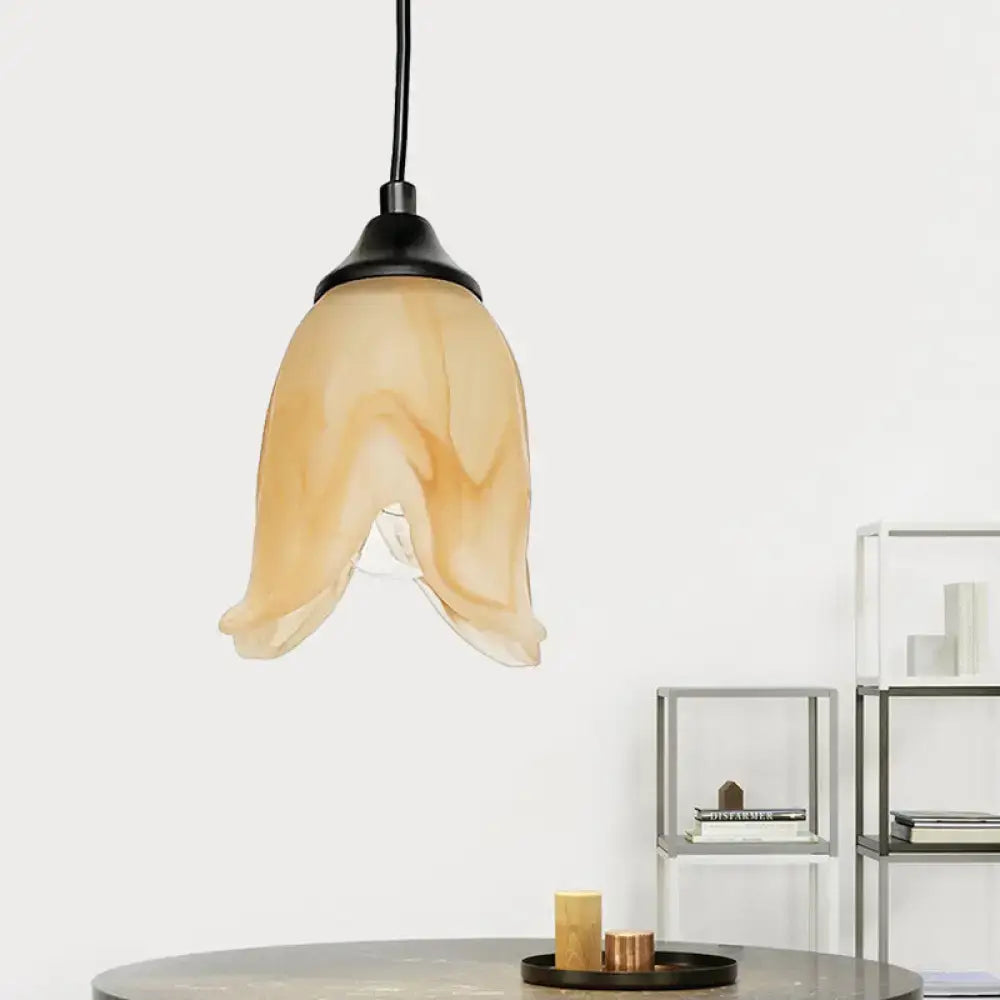 DecorBites™ warm amber glass pendant light with flower cone shape and black metal fixture for living room use