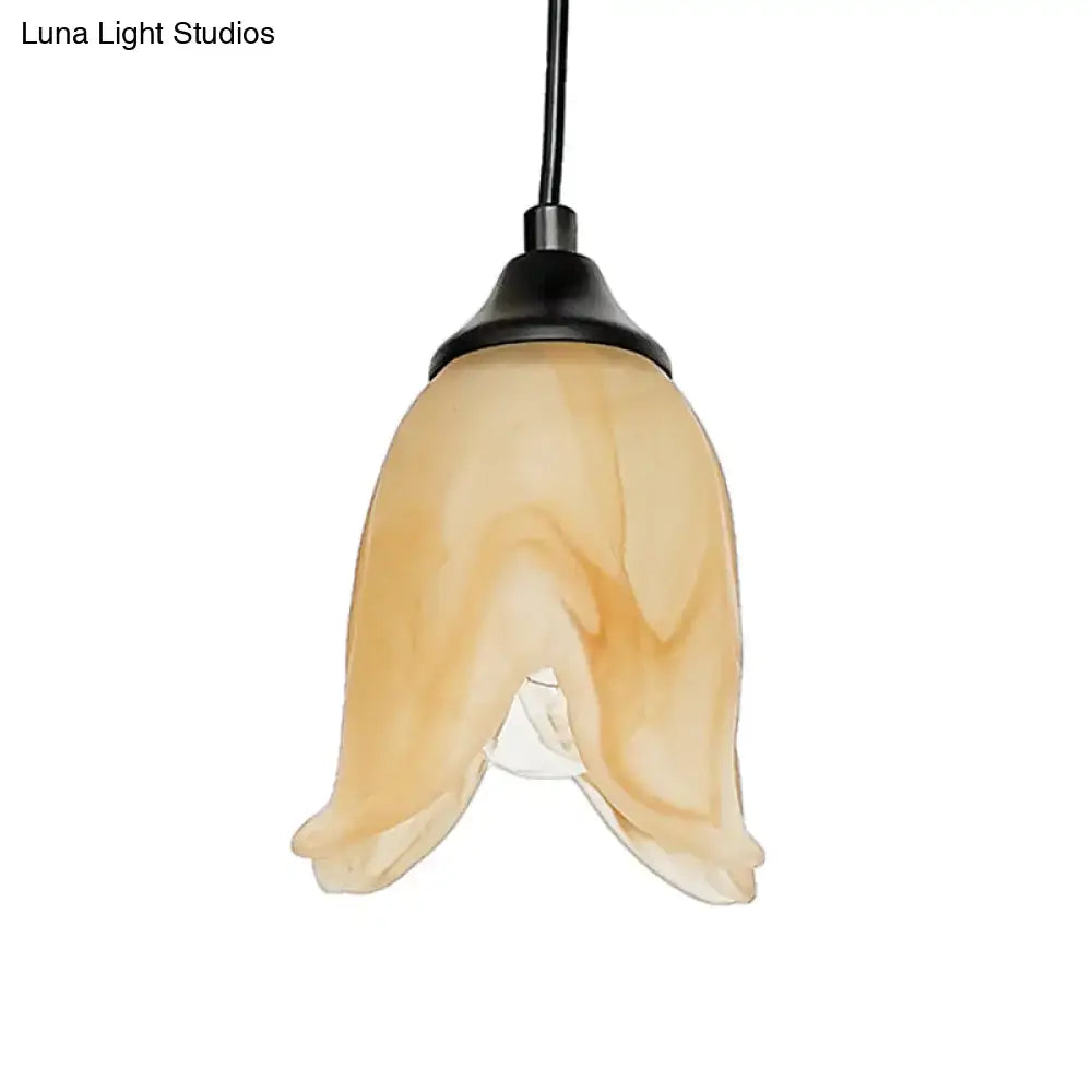 DecorBites traditional amber glass pendant light with flower cone shape and black metal fixture for living room use