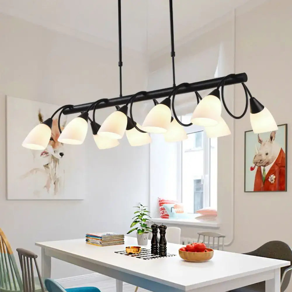 Black metal pendant light fixture with multiple frosted milky glass shades for elegant indoor lighting