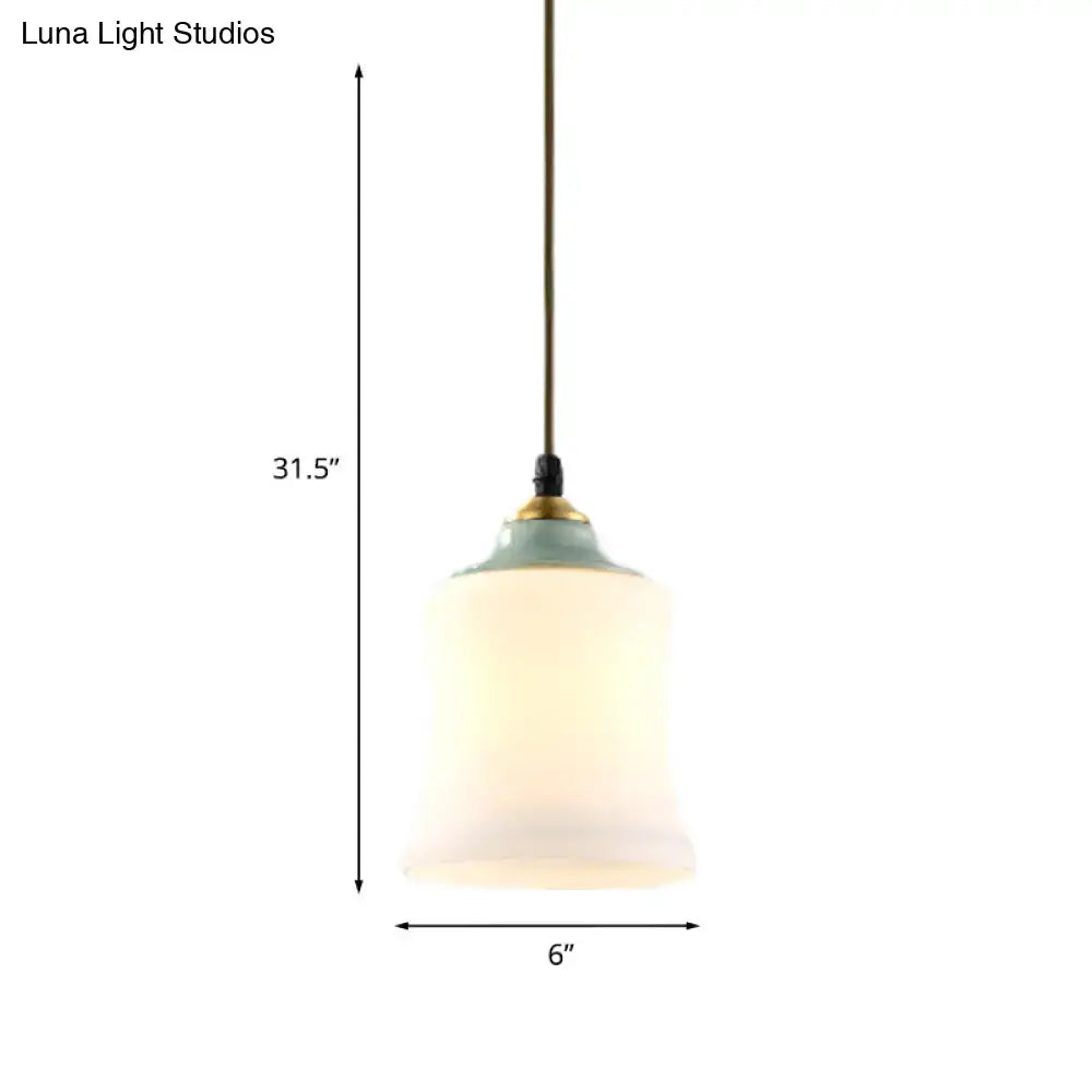 DecorBites traditional white glass pendant light with frosted glass, sage green ceramic top, and brass accents for restaurants