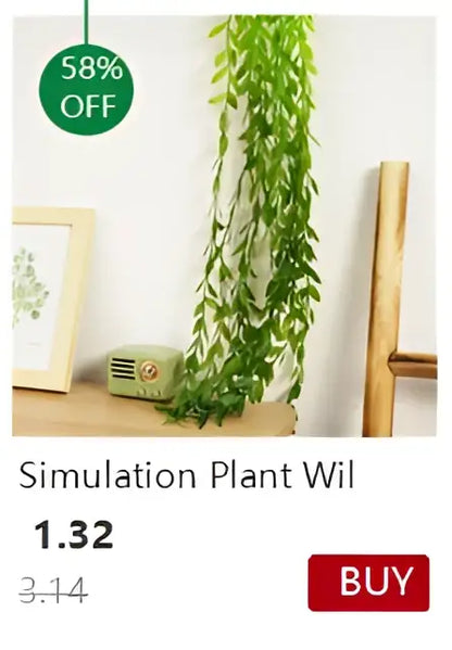 Green artificial hanging plant with long slender leaves in a transparent nordic vase by DecorBites for decoration