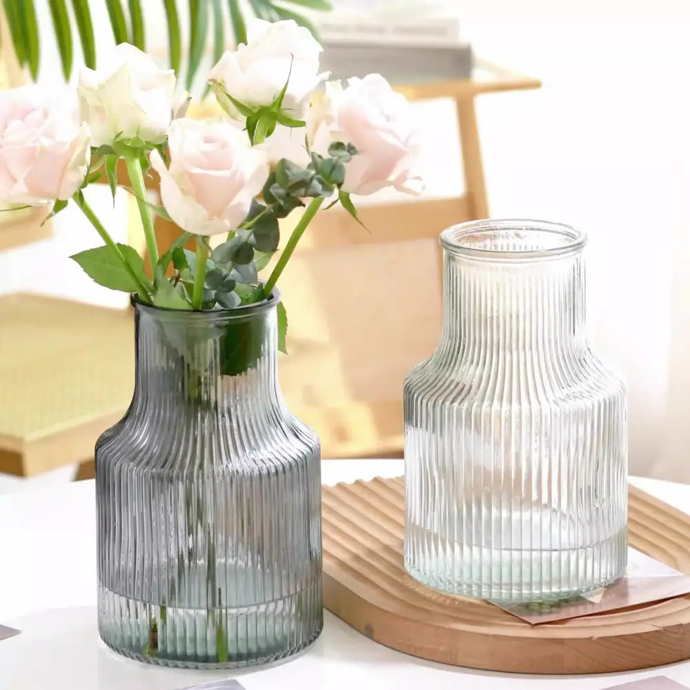 Two ribbed transparent nordic vases in muted gray and clear glass for plants and flowers by decorbites