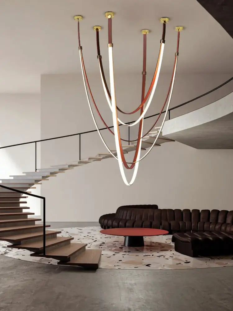 DecorBites™ trendy LED chandelier with multiple curved light tubes suspended by flexible leather belt straps in brown and cream