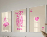Three framed wall art posters featuring pink playing card designs on beige background from DecorBites trendy retro set