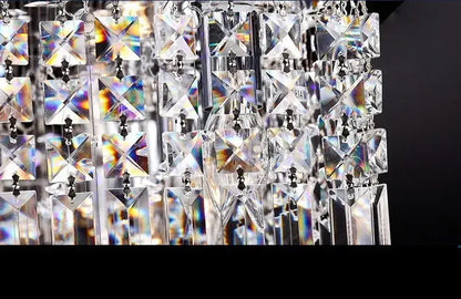 DecorBites upscale modern crystal chandelier with clear faceted glass prisms refracting light for dining room use