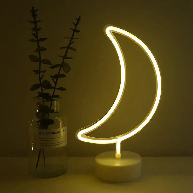 A glowing yellow led neon crescent moon lamp with sleek design and white marble base for decor and gifts