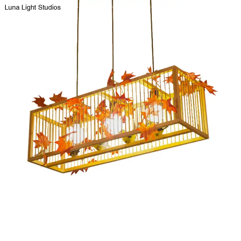 Vintage beige bamboo tea room pendant light with golden cage design and artificial orange red maple and green leaves decor