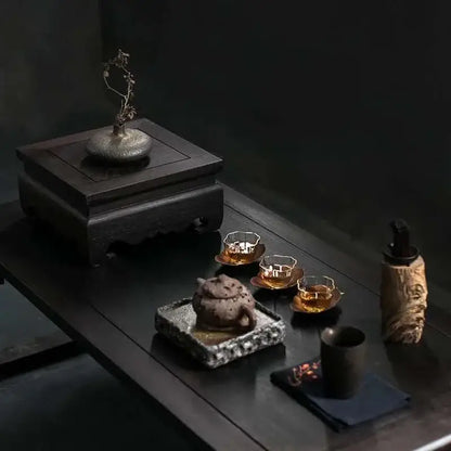 Dark wooden tea set with intricately carved base and matching teapot on stone tray complements chinese retro home decor