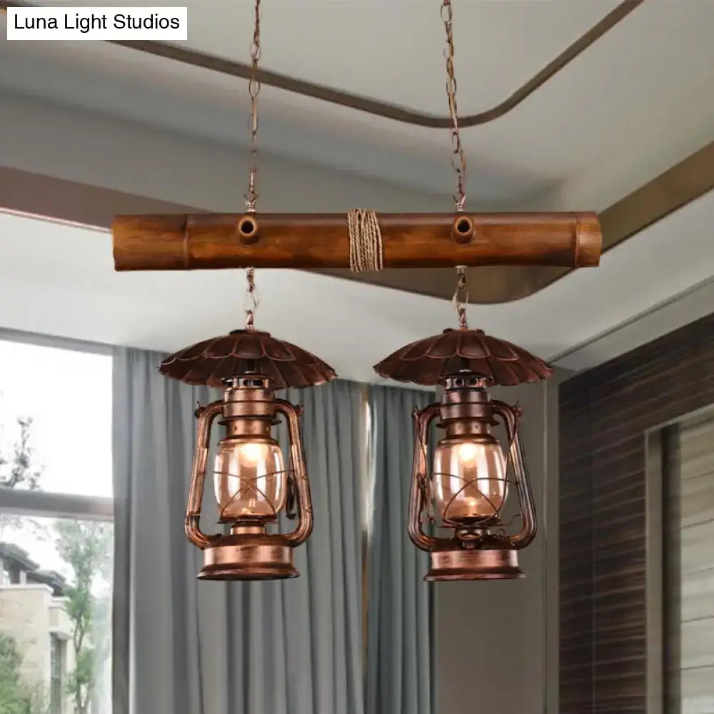 Decorbites™ vintage industrial 2-light island pendant in red brown with kerosene metallic chandelier finish above bamboo bar